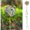 Antique birdhouse on pole with faucet and bird